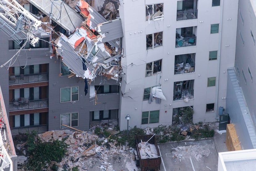 A crane sliced through the Elan City Lights apartments in June as a violent windstorm passed...