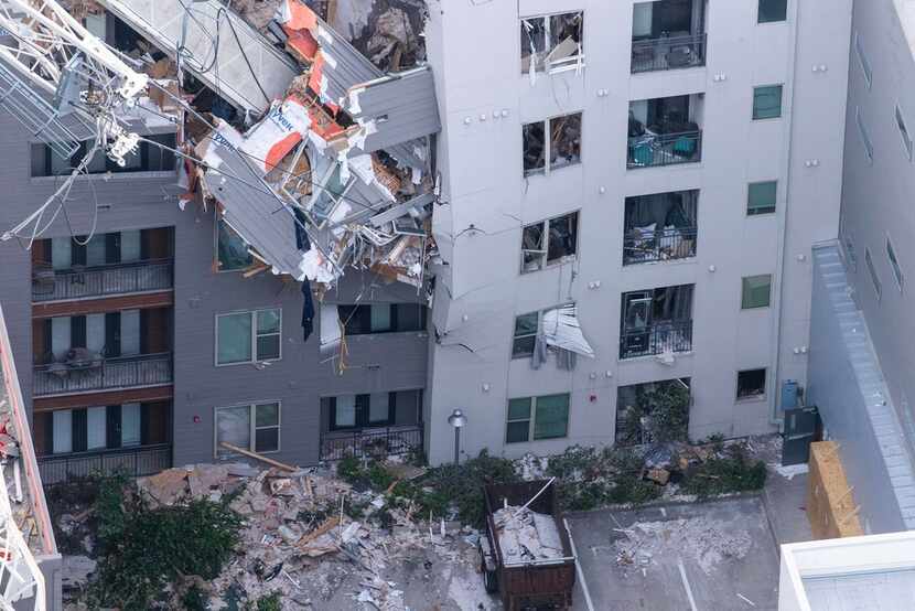A broken crane lies across the Elan City Lights apartments in Dallas on June 14, 2019. On...