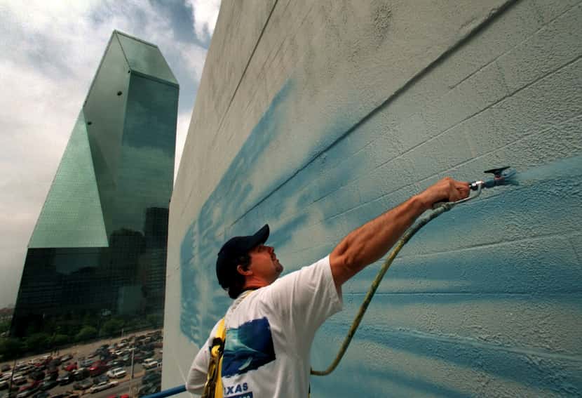 Wyland starts his giant mural of whales on the southwest side of 505 N. Akard St. in...