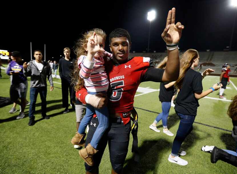 Mansfield Legacy quarterback Jalen Catalon (5) sings the school sing following their win...