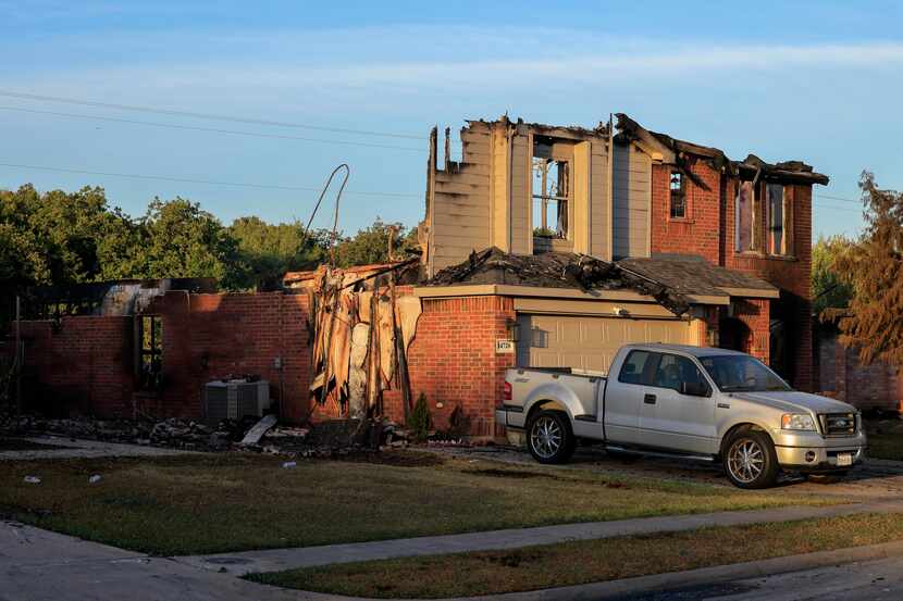 The charred remains of a home along Broadview Drive after a grass fire spread to a...