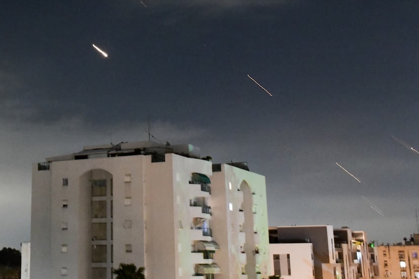 The Israeli Iron Dome air defense system launches Sunday to intercept missiles fired from...