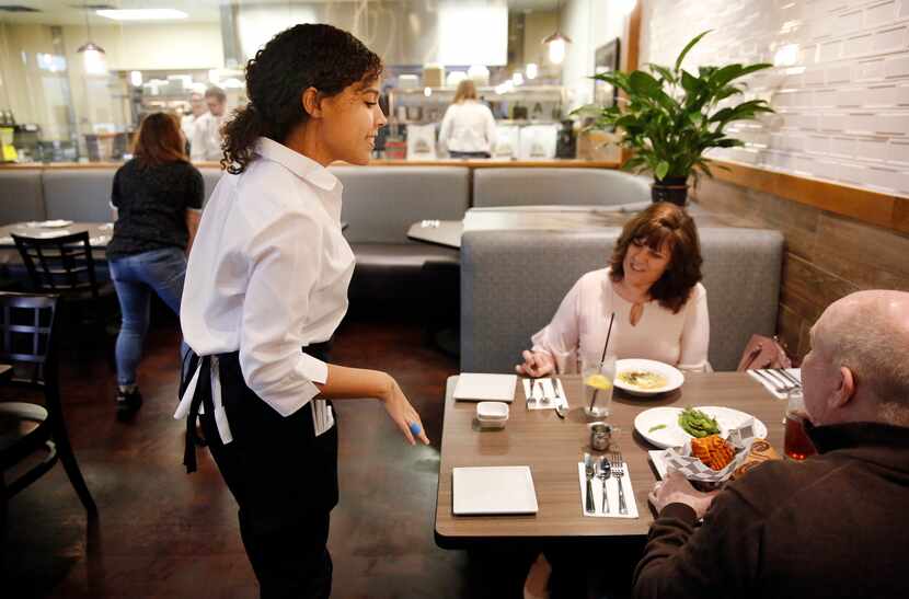Culinary student Miranda Landis (left) serves Angela England (center) and her husband Chris...