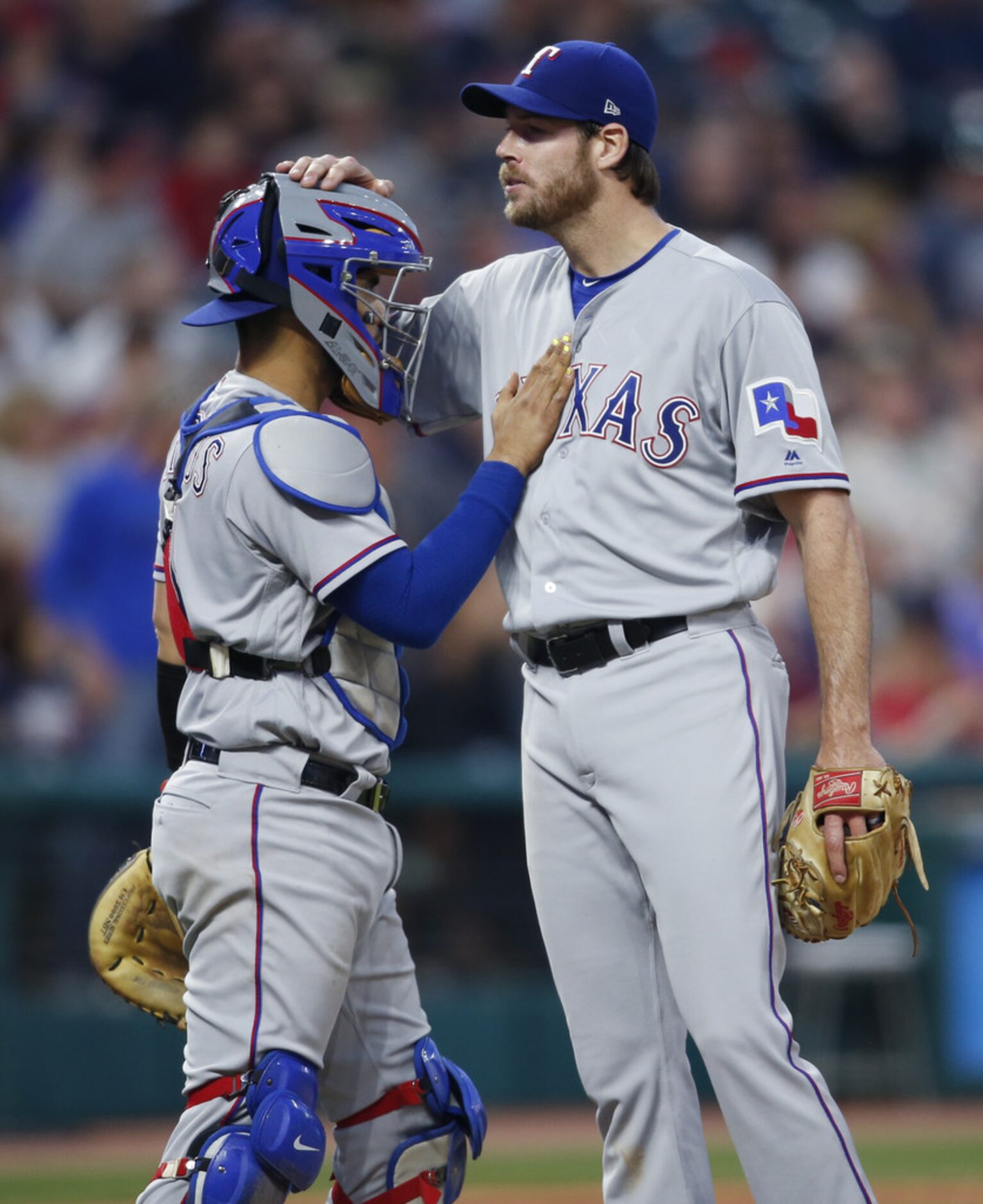 CLEVELAND, OH - MAY 01: Robinson Chirinos #61 of the Texas Rangers pats starting pitcher...