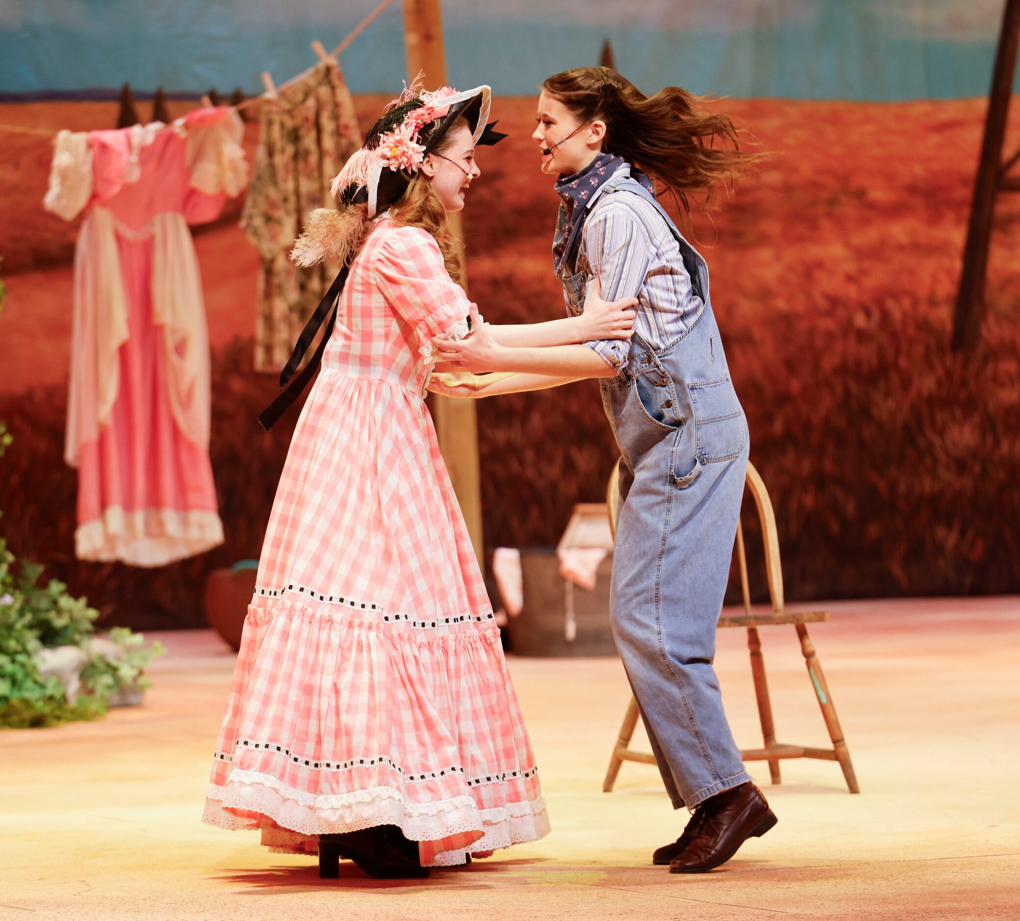 Avery Tollison (left) as Ado Annie, and Grey Dutton as Laurey act during the opening night...