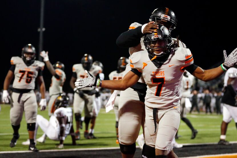 Lancaster running back Karon Neblett (7) celebrates his fourth quarter touchdown with...