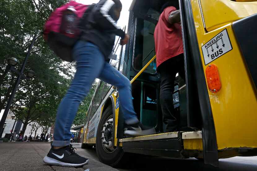 People board a DART bus at West Transfer Center in Dallas. 