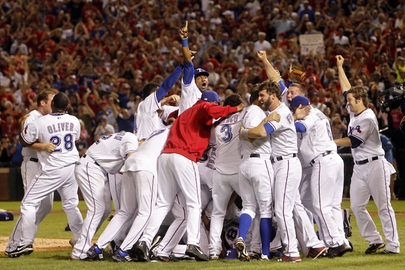 Rangers Julio Borbon (29) and teammates celebrate a victory over the New York Yankees during...
