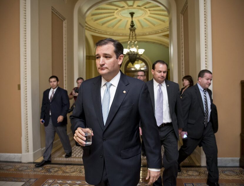  Tea party conservatives Sen. Ted Cruz, R-Texas, and Sen. Mike Lee, R-Utah, right, walk to a...