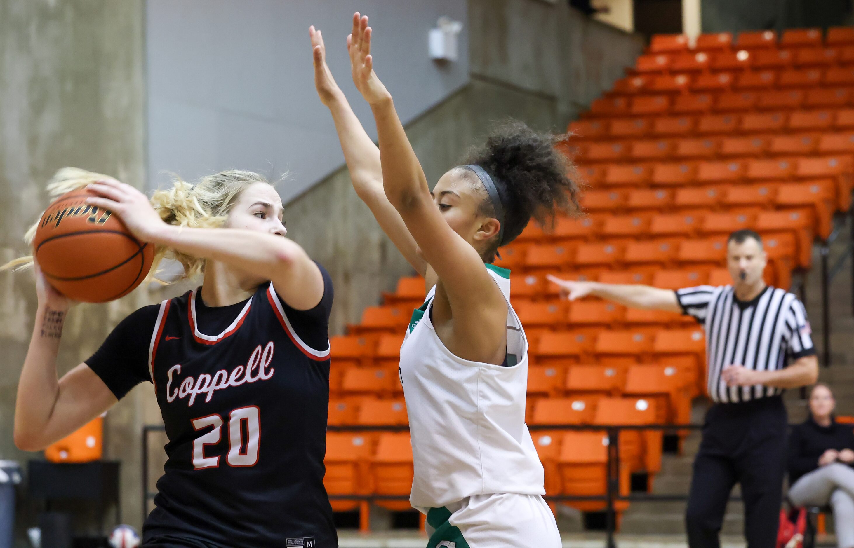 Coppell senior guard Julianna LaMendola (20) holds the ball up as she tries to moves around...