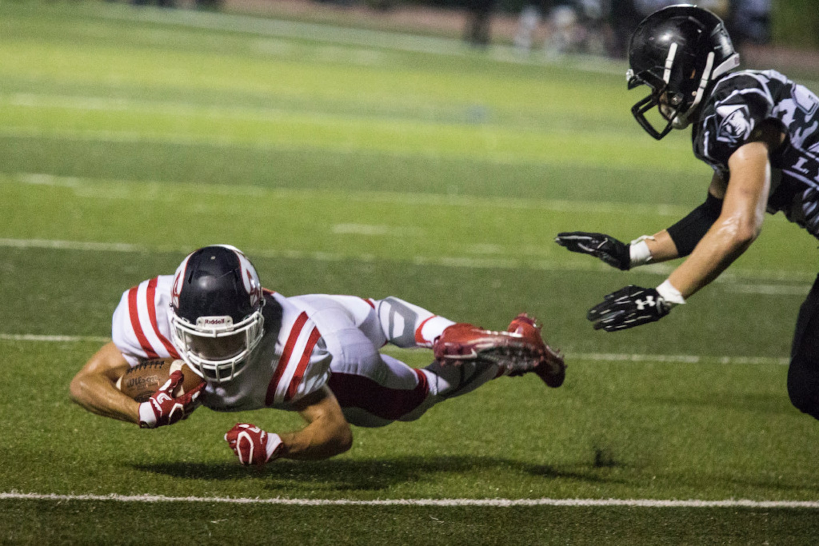 John Paul running back Avi Shapira (21) dives around a the defense for extra yards during...