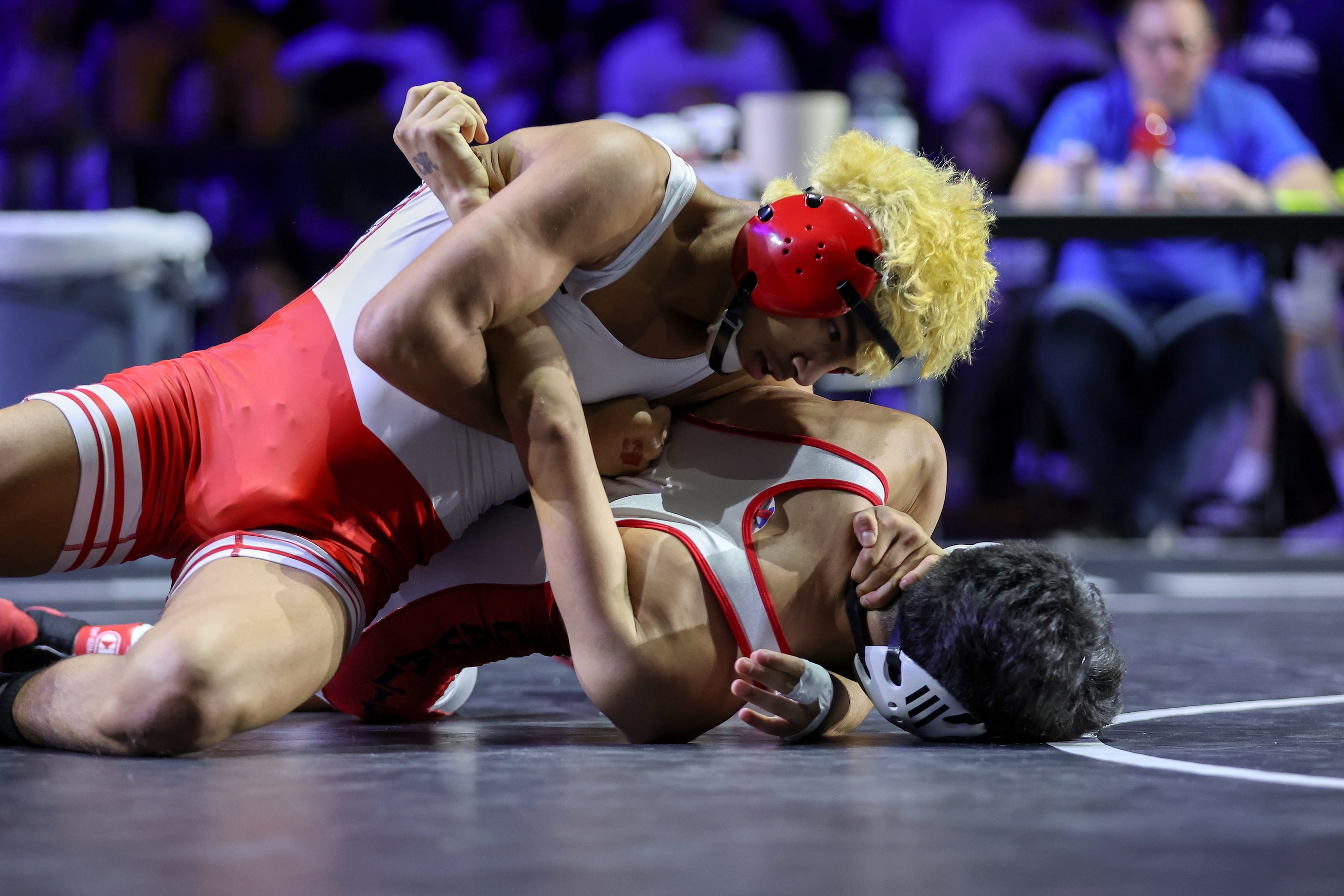 Isaak Arevalo (red) of Arlington Martin competes against Jonah Arellano of Austin Lake...