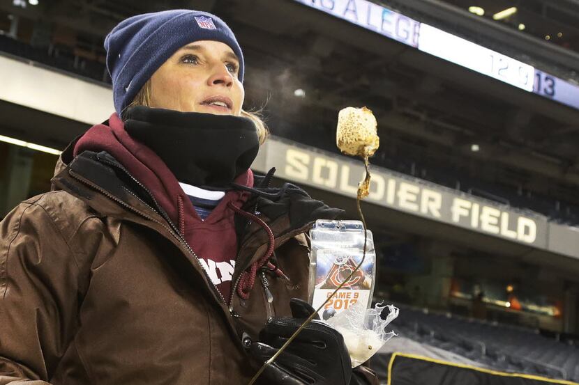 Dallas Cowboys radio sideline reporter Kristi Scales roasts a marshmallow on the on-field...