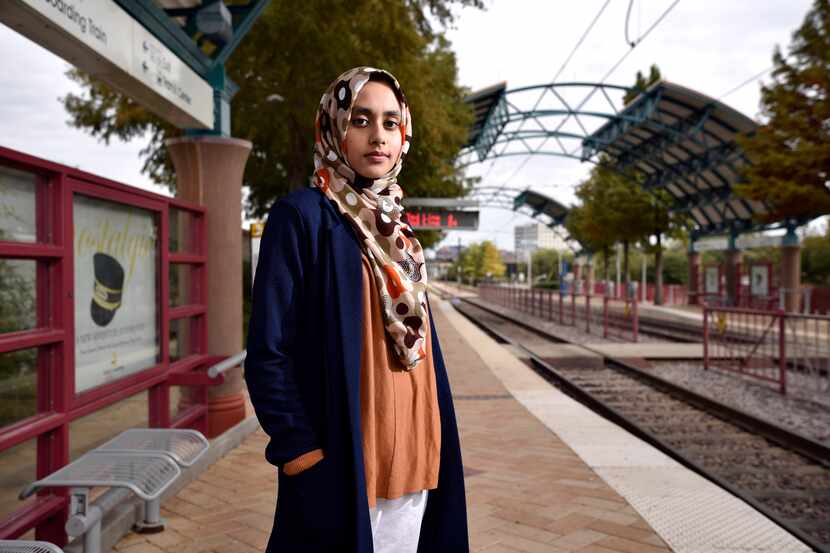 Aysha Khan, 21, a Muslim woman, rides the DART from Arapaho Center Station in Richardson to...