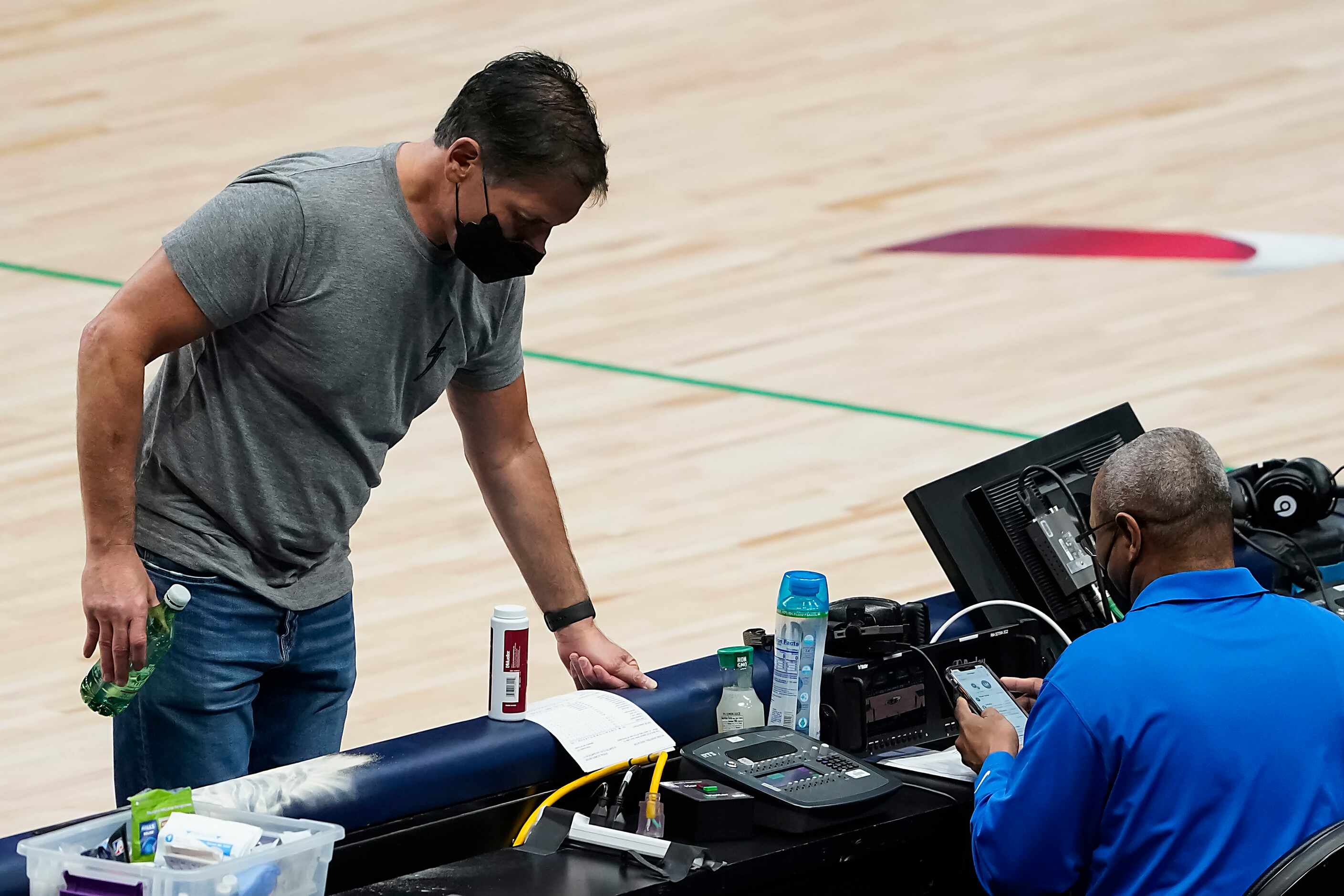Dallas Mavericks owner Mark Cuban checks the scorer’s table at the end of the first half of...