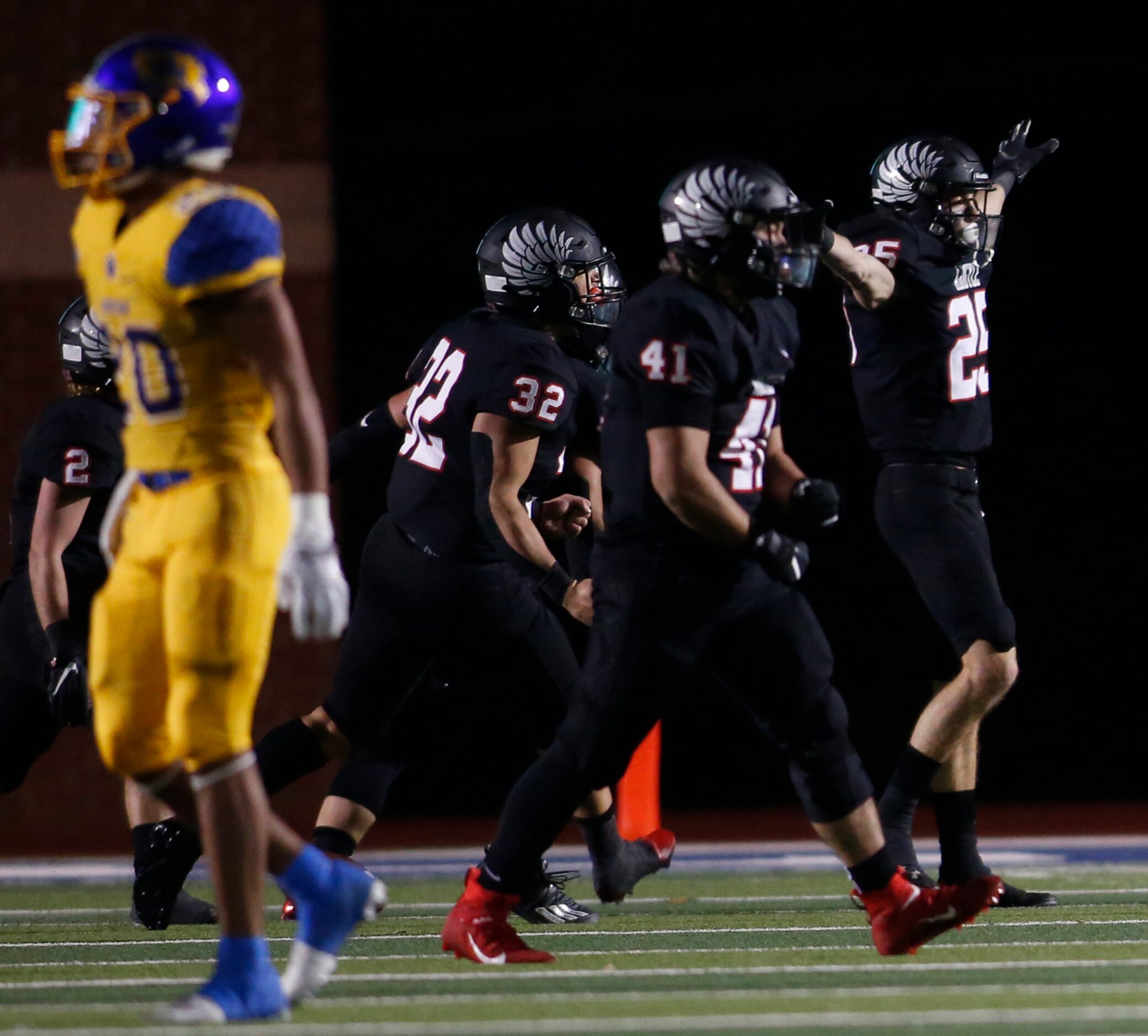 Argyle defensive back Hunter Roberts (25), right, sports his "Eagles" wings after breaking...