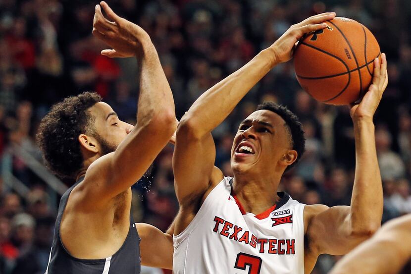 Texas Tech's Zhaire Smith (2) looks for a shot against Nevada's Caleb Martin (10) during the...
