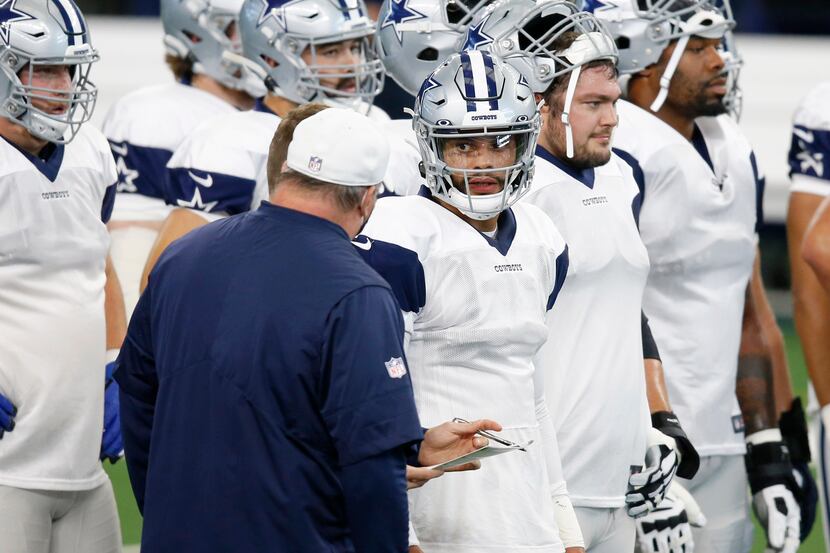 Dallas Cowboys quarterback Dak Prescott (4) talks with Dallas Cowboys head coach Mike...