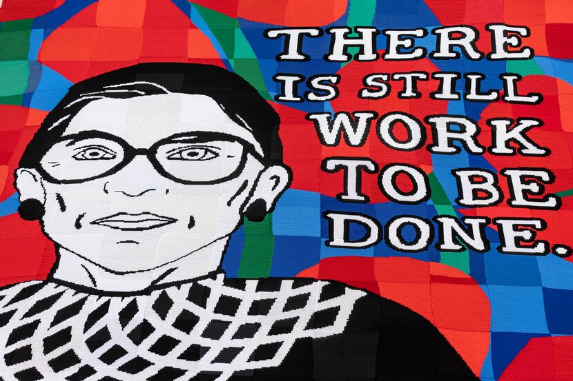 A Crochet portrait of Ruth Bader Ginsburg hangs on the front of the Dallas Public Library's...