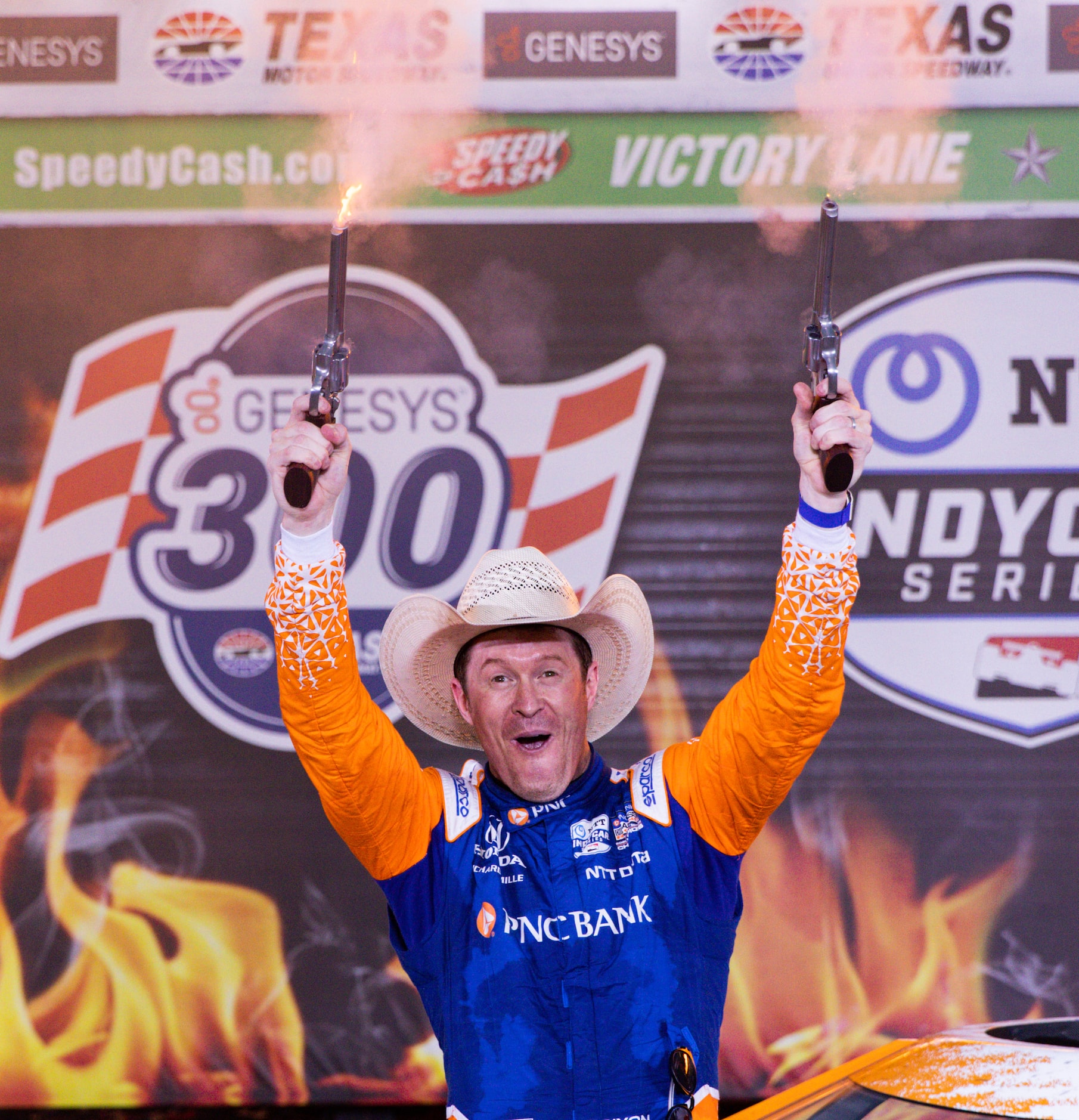 Scott Dixon (#9) celebrates in Victory Lane by firing the six-shooters after winning the...