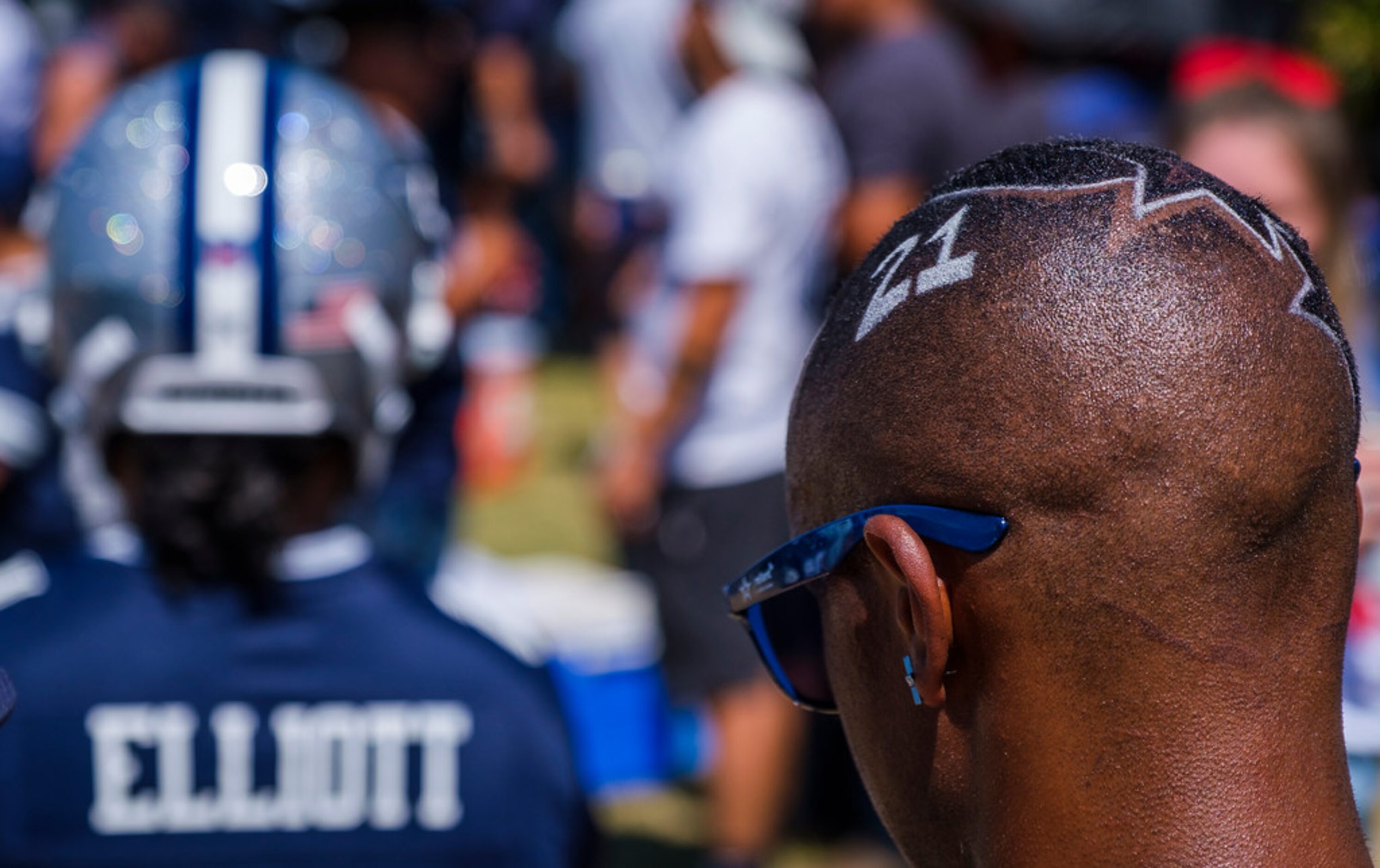 A fan spots the number for Dallas Cowboys running back Ezekiel Elliott in his hair while...