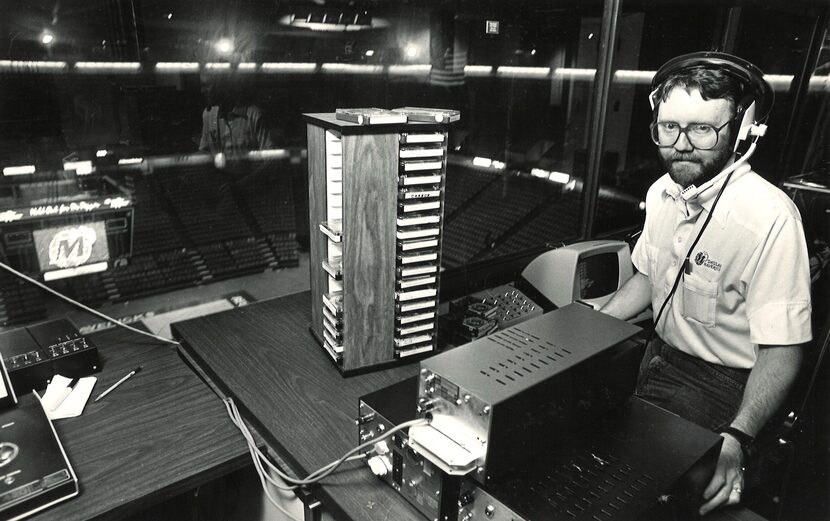 Mike Garner sits in the booth from which he controls the Reunion Arena PA system and...