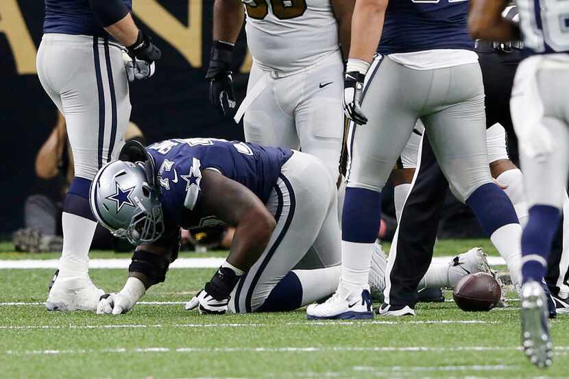 Dallas Cowboys offensive tackle Tyron Smith (77) is slow to get up after getting injured on...