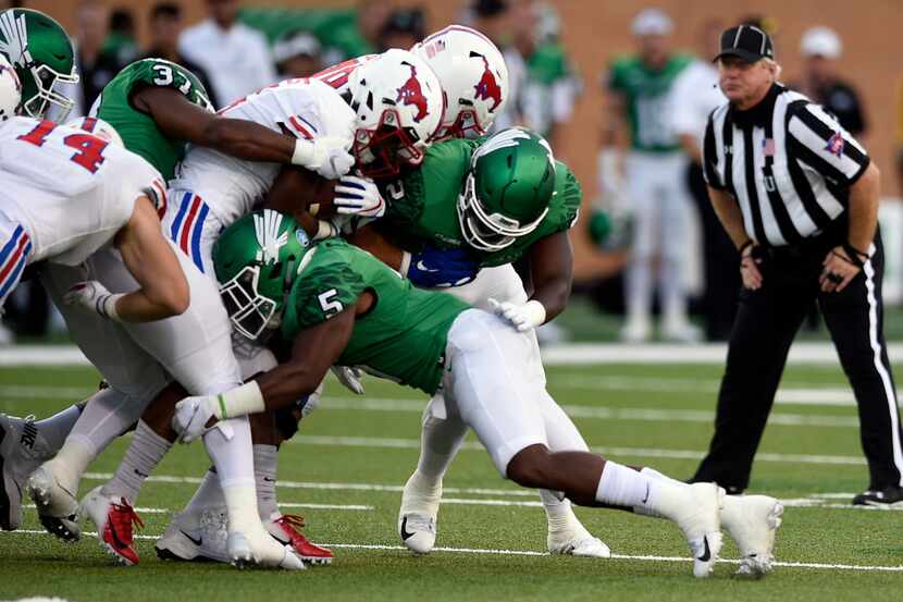 North Texas safety Tyreke Davis (5) makes a tackle during the Mean Green's win over SMU...