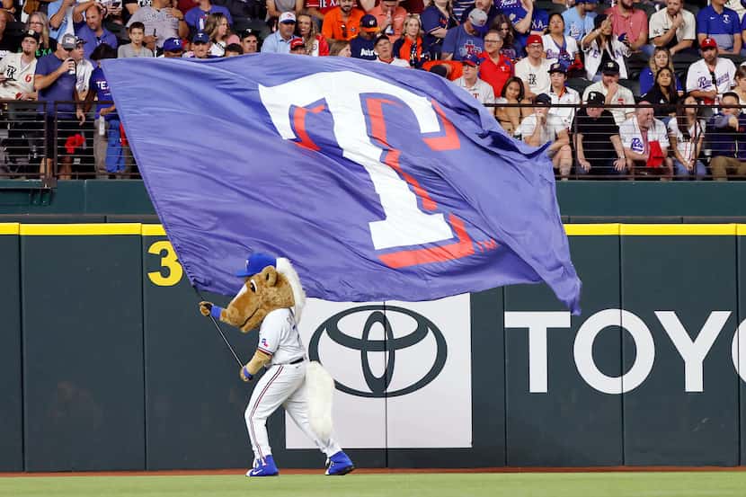 Texas Rangers mascot Captain waves the team flag during the sixth inning dot race in Game 4...