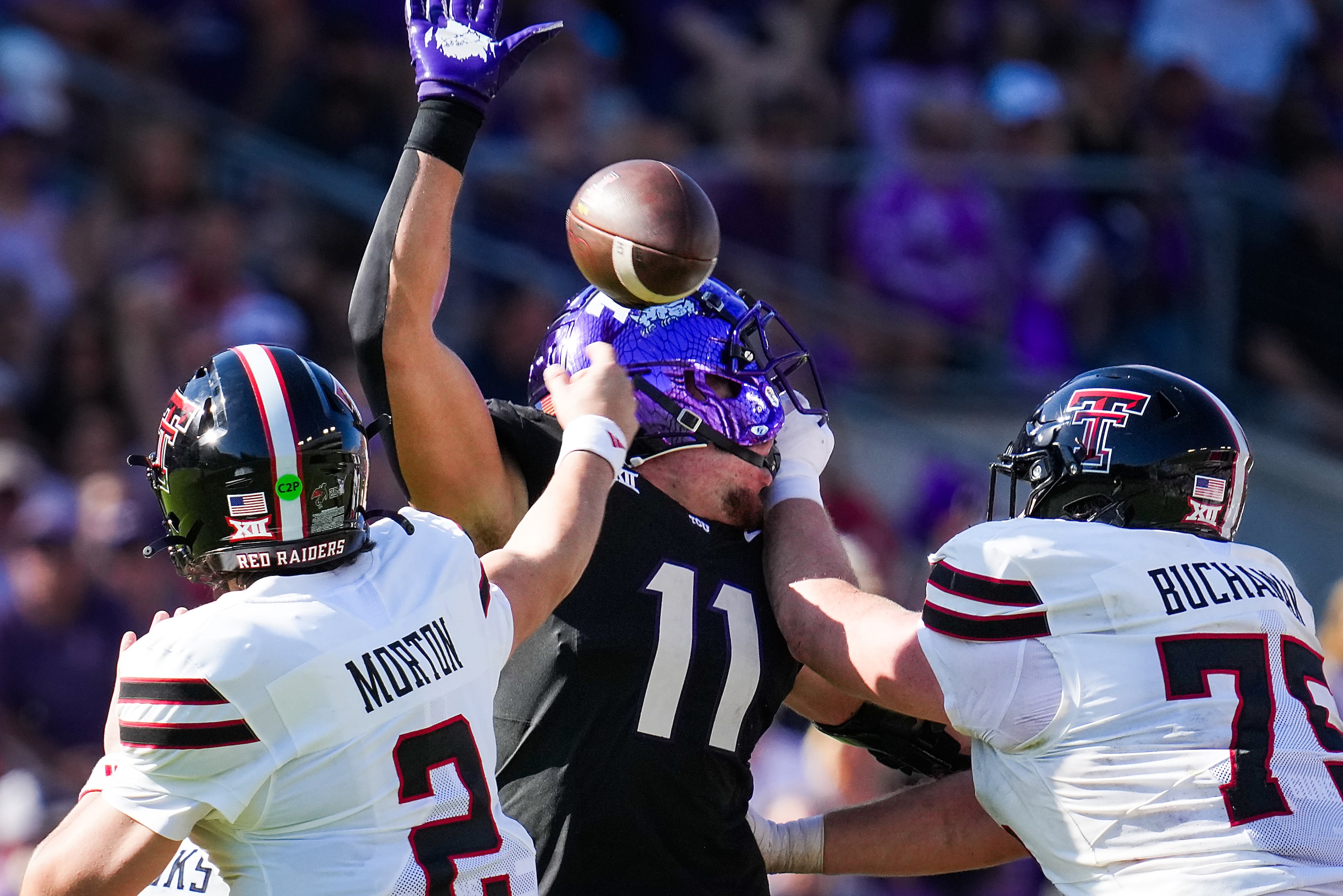 Texas Tech quarterback Behren Morton (2) throws a pass as TCU linebacker Devean Deal (11)...