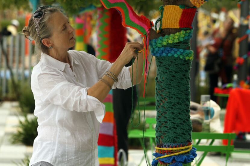 Volunteers including Lisa Payne wrapped park surfaces in knitted and crocheted decorations...