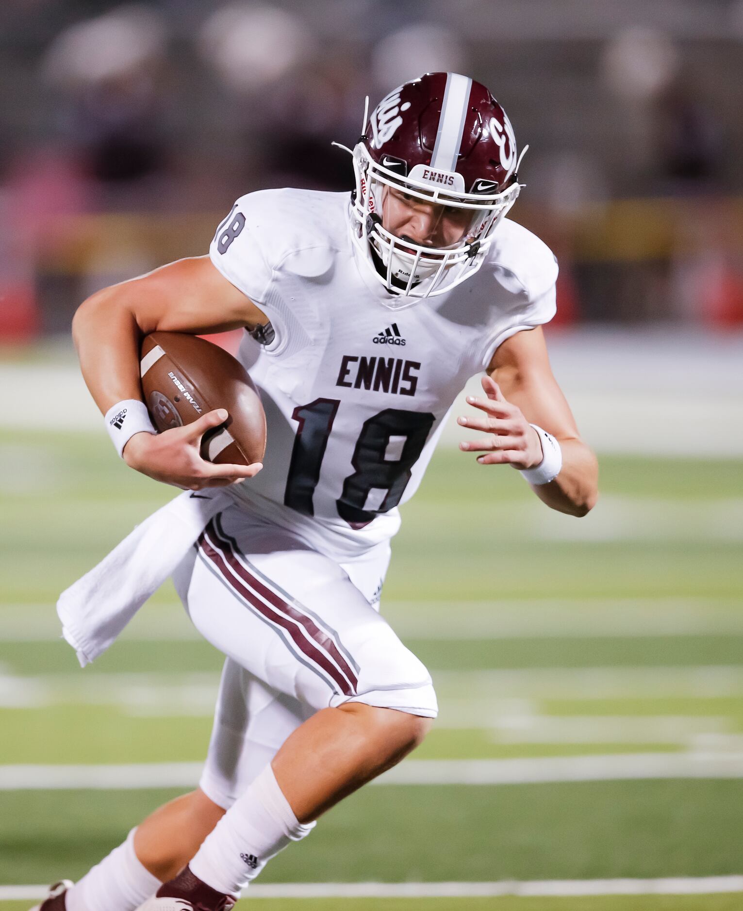 Ennis senior quarterback Collin Drake carries the ball in for a touchdown during the first...