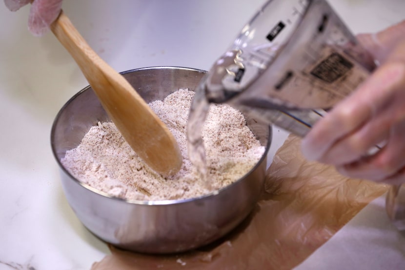 Dotty Griffith mixes blue corn tortilla dough 