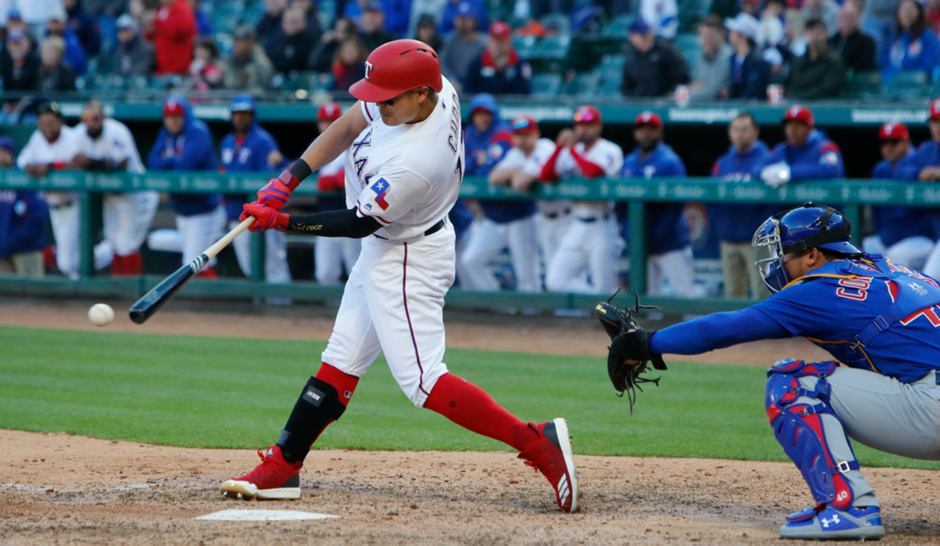 Texas Rangers Shin-Soo Choo (17) of South Korea makes contact for a ground out in front of...