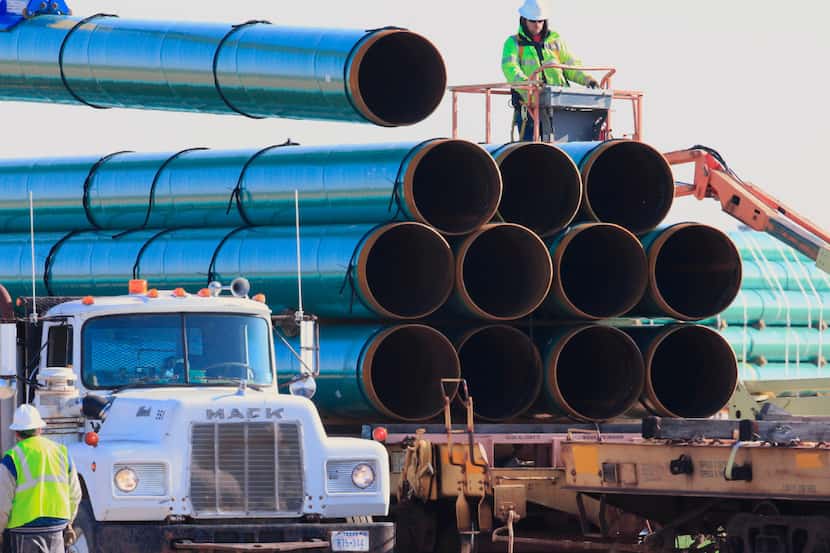 FILE - In this May 9, 2015, file photo, workers unload pipes in Worthing, S.D., for the...