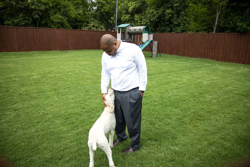  Eric Johnson with his new dog, Penny, in the backyard of his East Dallas home. (Shaban...