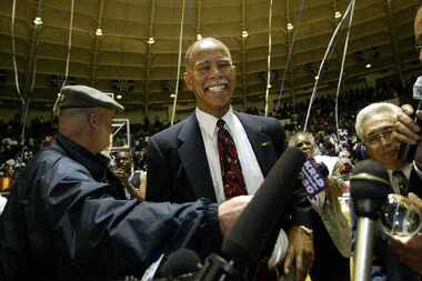 February 11, 2003 -- Fort Worth Dunbar Coach Robert Hughes is all smiles after gaining his...