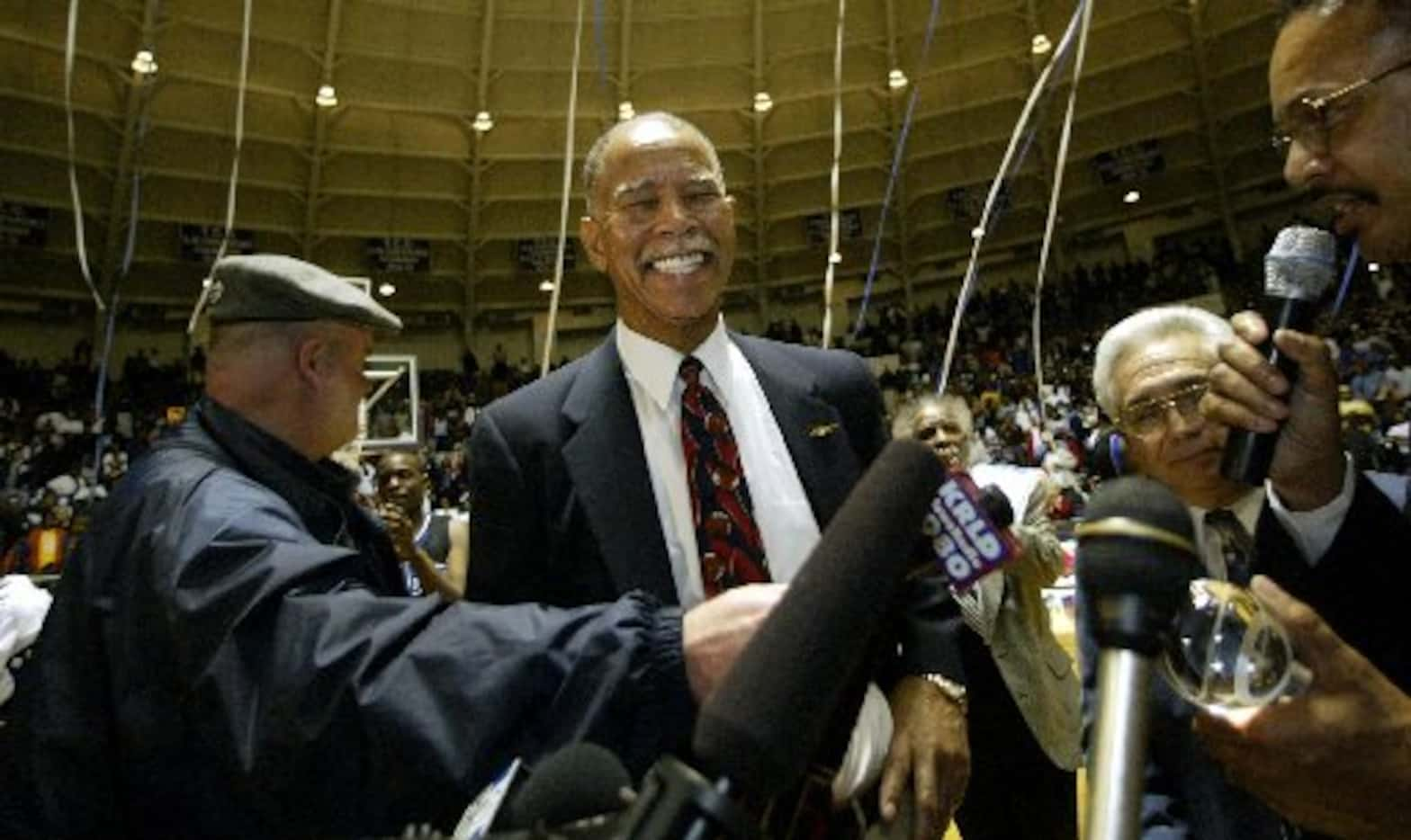 February 11, 2003 -- Fort Worth Dunbar Coach Robert Hughes is all smiles after gaining his...