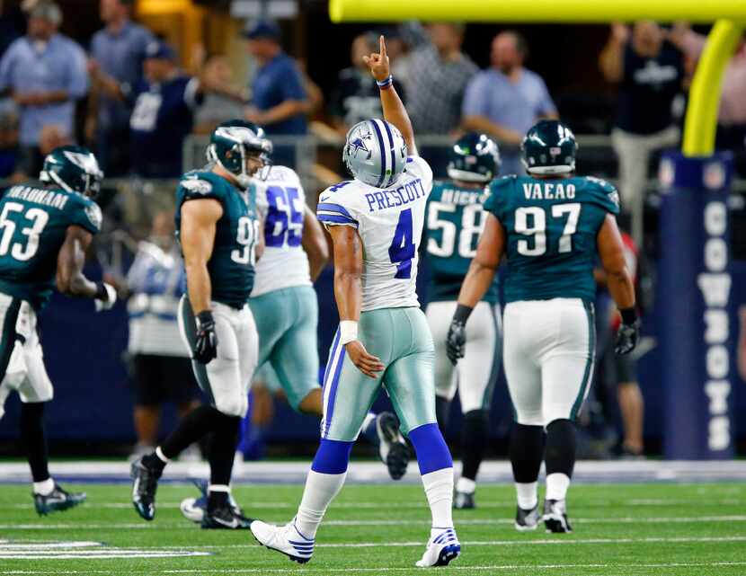 Dallas Cowboys quarterback Dak Prescott (4) points skyward after he threw Dez Bryant a...