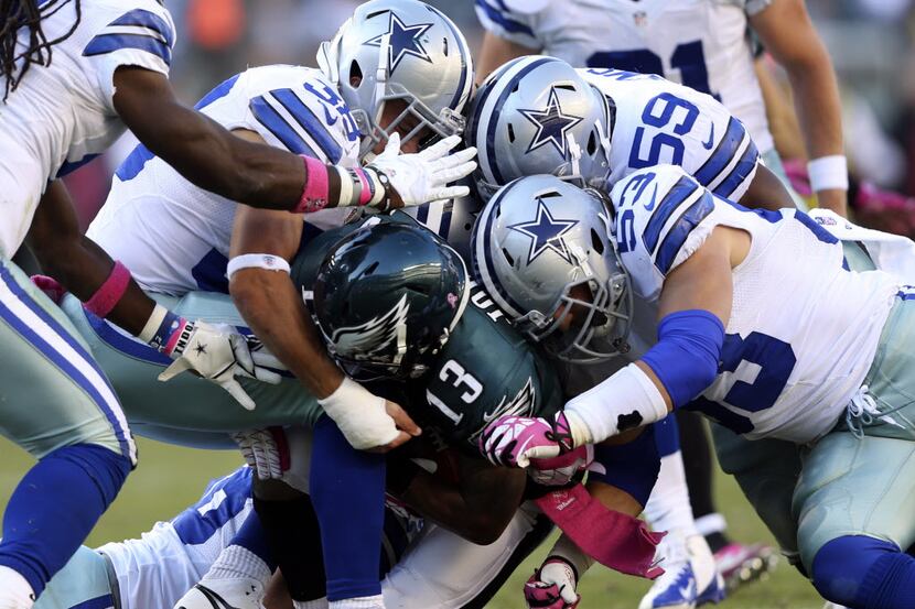 Philadelphia Eagles wide receiver Damaris Johnson (13) is tackled by Dallas Cowboys...