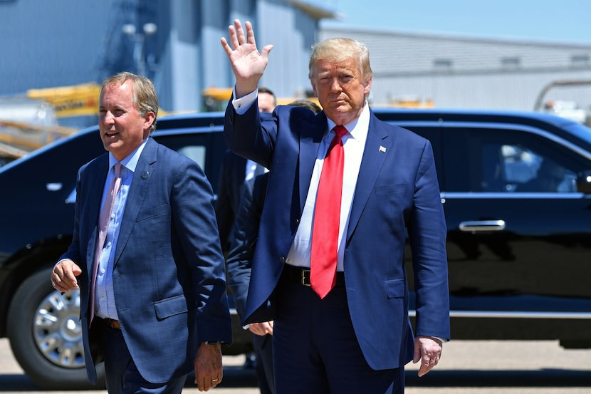 Texas attorney general Ken Paxton greets President Donald Trump at Dallas Love Field on June...