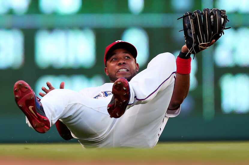 ARLINGTON, TX - JUNE 26:  Elvis Andrus #1 of the Texas Rangers fields a popup for the out...