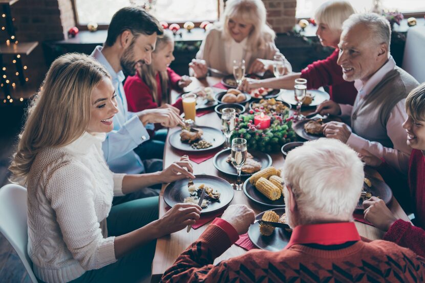 Family gathering around the dinner table for Christmas.