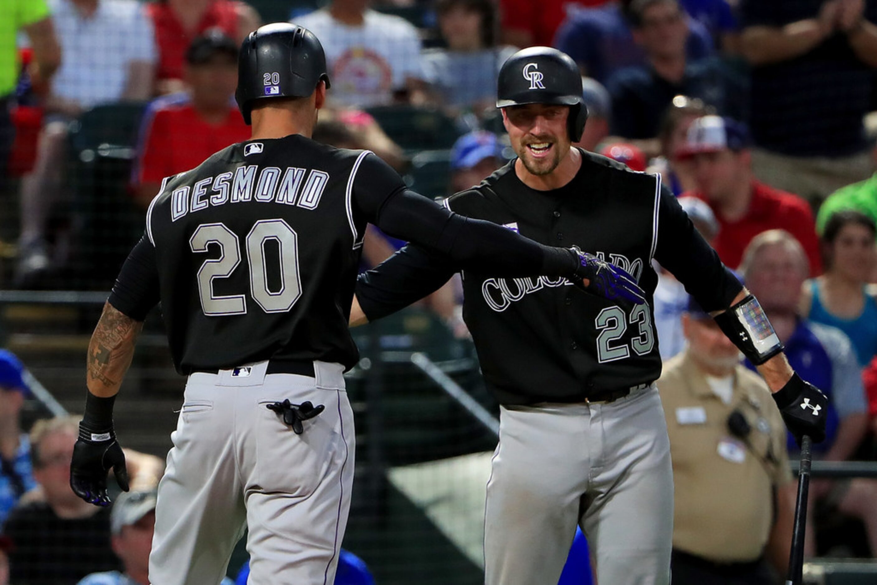 ARLINGTON, TX - JUNE 15:  Ian Desmond #20 of the Colorado Rockies celebrates with Tom Murphy...