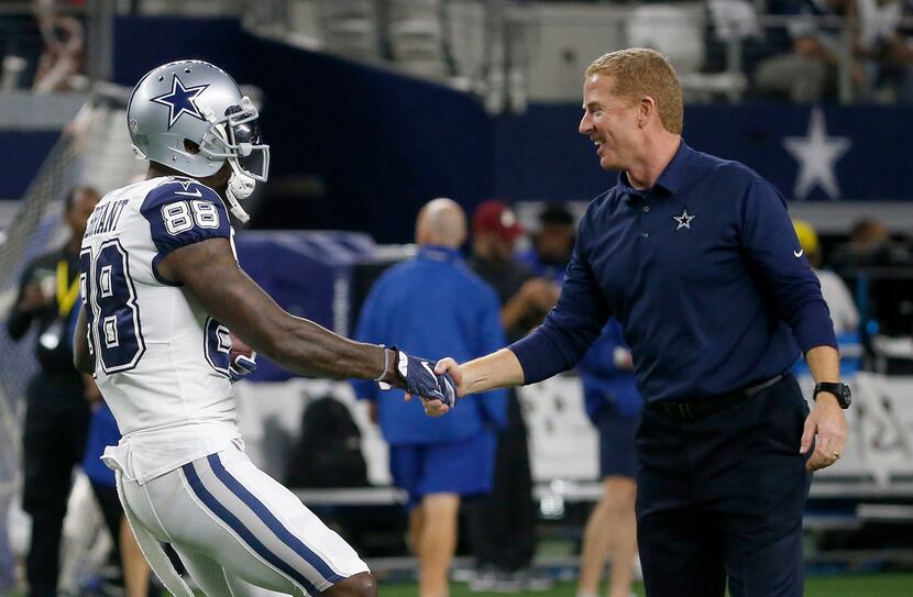 Dallas Cowboys head coach Jason Garrett (right) shakes hands with wide receiver Dez Bryant...