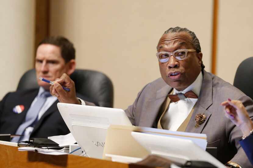 Dallas County Commissioner John Wiley Price (center) speaks next to County Judge Clay...
