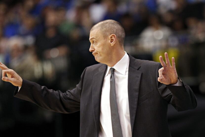 Dallas Mavericks head coach Rick Carlisle signals to players during the first half of their...