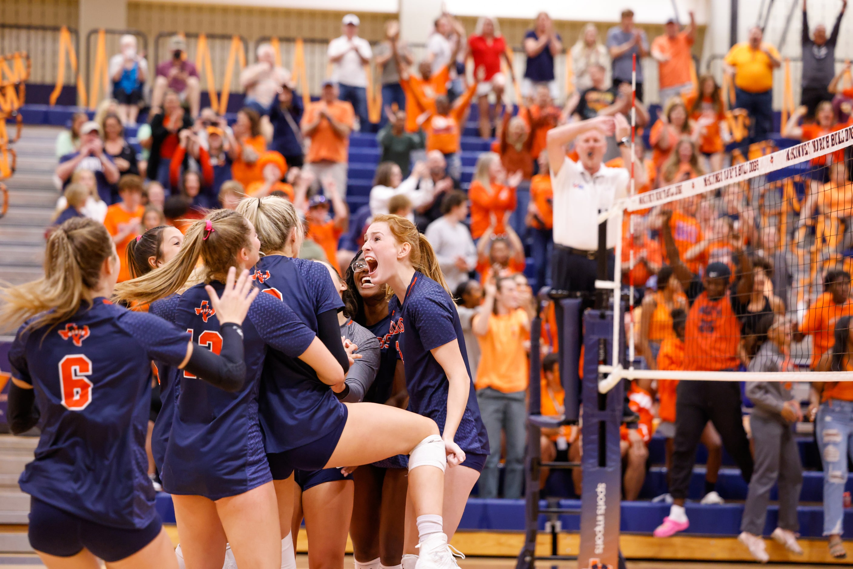 McKinney North surrounds Natalie Hughes (19) to cheer celebrate her winning point against...