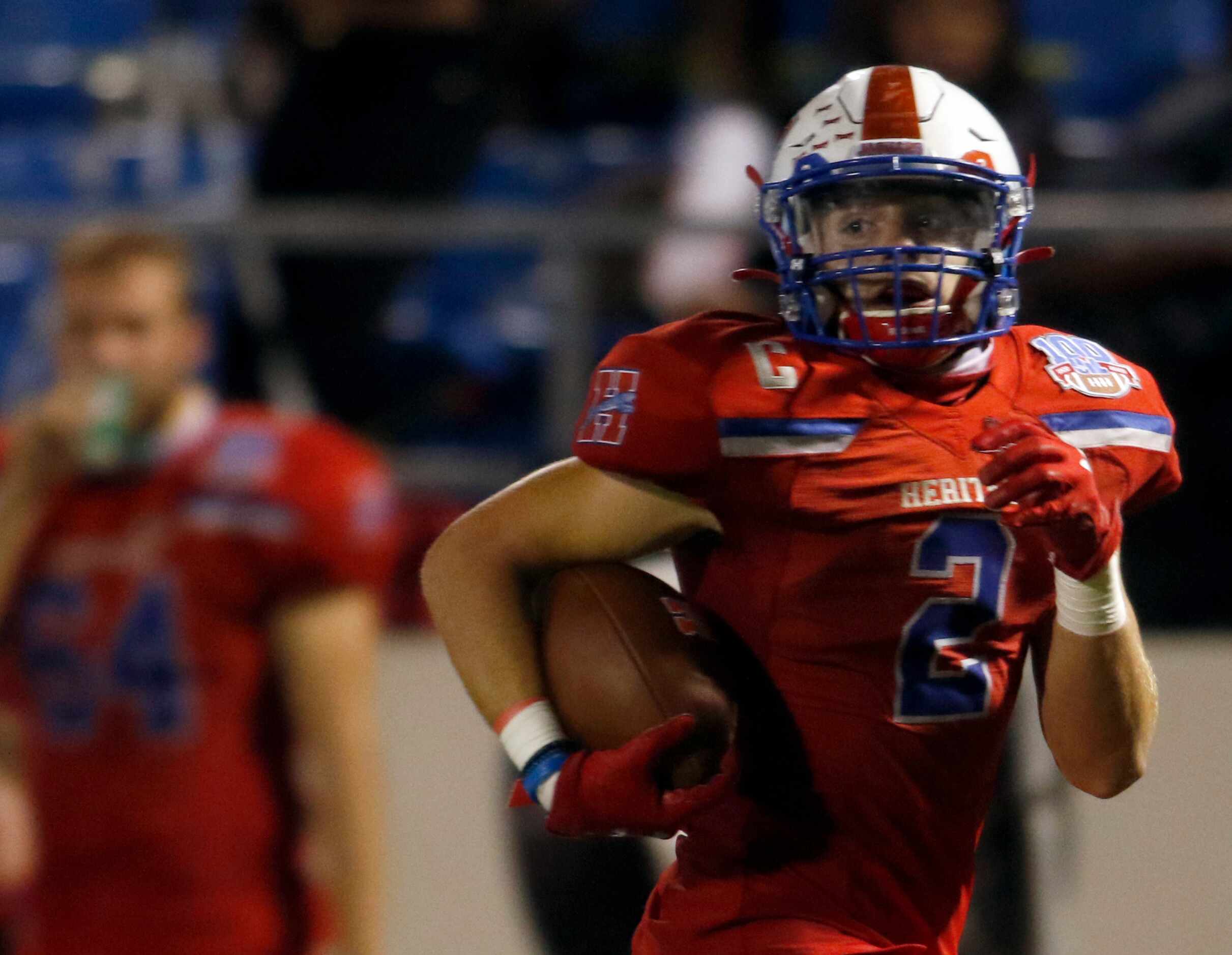 Midlothian Heritage running back Cullen Stone (2) looks over his shoulder enroute to a long...