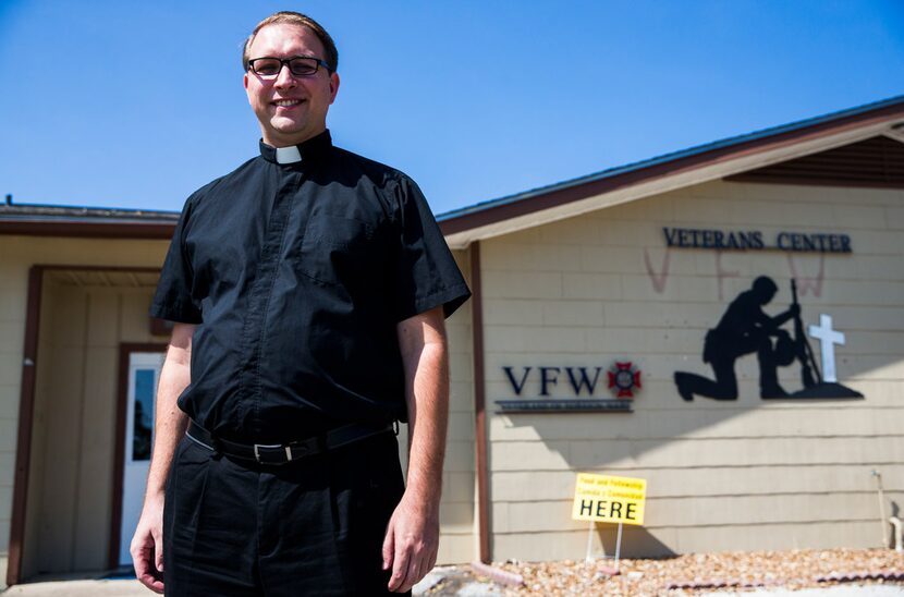 The Rev. Matthew Kinney of Sacred Heart Catholic Church poses for a portrait outside the...